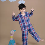 A boy wearing checks cotton night suit