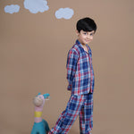 A boy wearing checks cotton night suit
