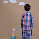 A boy wearing checks cotton night suit