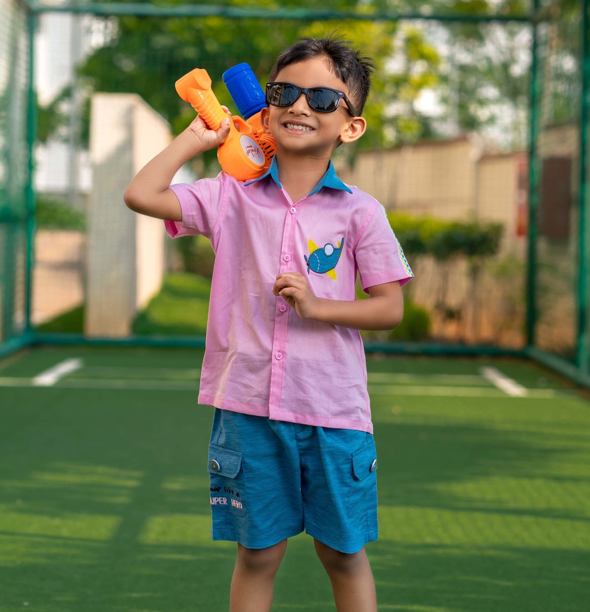 Candy Pink Boy wearing Candy pink Aeroplane shirt & light Denim Shorts