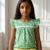 Green floral top and yellow shorts