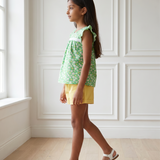 Green floral top and yellow shorts